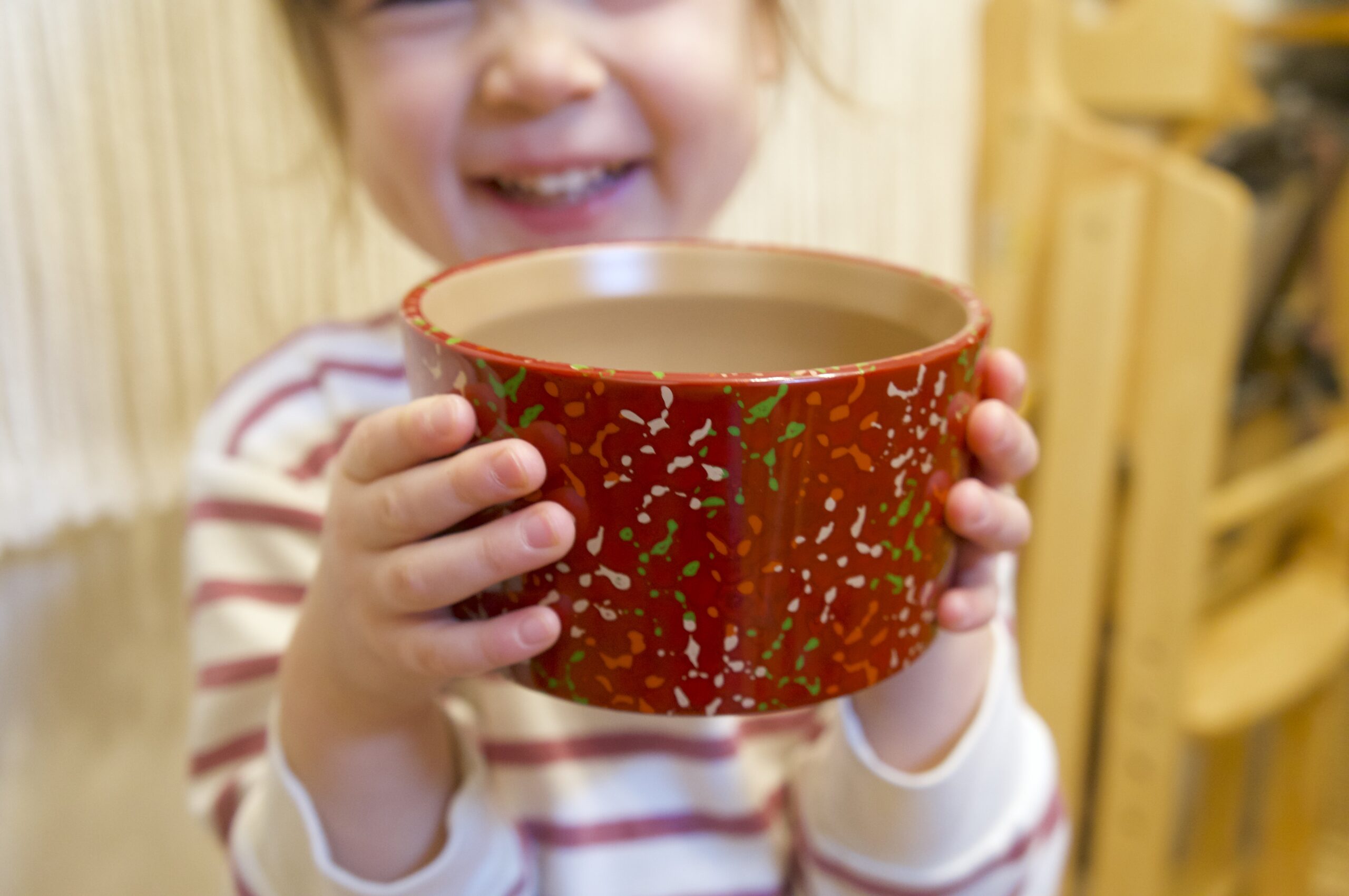 girl-smiling-holding-bowl-